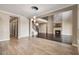 Bright open-concept living space featuring stone fireplace, staircase, stylish pendant lighting and wood-look tile flooring at 4717 Emerald Palms Ct, Winter Haven, FL 33884