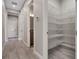 Walk-in pantry features white wire shelving and wood-look tile floors at 4717 Emerald Palms Ct, Winter Haven, FL 33884