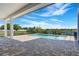 A covered patio features a view of the pool and a tranquil lake view at 4717 Emerald Palms Ct, Winter Haven, FL 33884