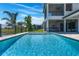 Inviting in-ground pool overlooking lake and well-manicured backyard at 4717 Emerald Palms Ct, Winter Haven, FL 33884
