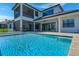 Beautiful in-ground pool with screened-in lanai and outdoor kitchen at 4717 Emerald Palms Ct, Winter Haven, FL 33884