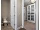 Walk-in closet next to toilet featuring a closet with mirrored door and built-in shelving and drawers at 4717 Emerald Palms Ct, Winter Haven, FL 33884