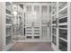 Spacious walk-in closet features custom shelving, drawers, mirrored accents and carpeted flooring at 4717 Emerald Palms Ct, Winter Haven, FL 33884