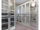 Bright walk-in closet features custom shelving, drawers, mirrored accents and carpeted flooring at 4717 Emerald Palms Ct, Winter Haven, FL 33884