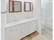 Well-lit bathroom featuring a double vanity, modern mirrors, and a separate shower and toilet area at 4986 Foxwood Lake Dr, Lakeland, FL 33810