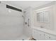 Clean bathroom with shower, accessible grab bar, and a vanity with a modern mirror and ample storage space at 4986 Foxwood Lake Dr, Lakeland, FL 33810