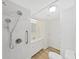 Bright bathroom with a tiled shower and grab bar, modern fixtures, and a clean, updated vanity at 4986 Foxwood Lake Dr, Lakeland, FL 33810