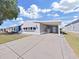 Charming single-story home features a carport, mature tree, and well-maintained front lawn at 4986 Foxwood Lake Dr, Lakeland, FL 33810