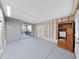 Unfinished garage features gray walls and floor with exposed framework, offering ample space for storage or projects at 4986 Foxwood Lake Dr, Lakeland, FL 33810