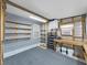 Unfinished garage with a pegboard, gray walls, and concrete floor offering ample space for storage or projects at 4986 Foxwood Lake Dr, Lakeland, FL 33810