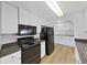 Eat-in kitchen with modern appliances, white cabinets and neutral plank flooring at 4986 Foxwood Lake Dr, Lakeland, FL 33810