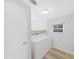 Well-lit laundry room featuring a washer, dryer, storage cabinets, and a window for natural light at 4986 Foxwood Lake Dr, Lakeland, FL 33810