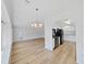 Open living room and kitchen with wood floors and modern lighting at 4986 Foxwood Lake Dr, Lakeland, FL 33810