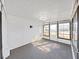 Bright sunroom featuring an ample window set with a gray carpet flooring, perfect for relaxation and enjoying sunlight at 4986 Foxwood Lake Dr, Lakeland, FL 33810