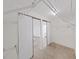 Spacious walk-in closet featuring ample shelving, sliding door access, and neutral carpeting for organized storage at 4986 Foxwood Lake Dr, Lakeland, FL 33810