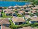 Aerial view of the house showcases the neighborhood and close proximity to a lake at 5325 Nicklaus Dr, Winter Haven, FL 33884
