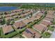 An aerial shot showcases the property among well-manicured lawns in a lakeside community with mature trees and scenic views at 5325 Nicklaus Dr, Winter Haven, FL 33884