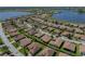 Aerial view of a community nestled between scenic lakes, highlighting the homes and tranquil surroundings at 5325 Nicklaus Dr, Winter Haven, FL 33884