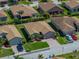 Aerial view of a single-story home with a brick driveway and tropical landscaping in a residential neighborhood at 5325 Nicklaus Dr, Winter Haven, FL 33884
