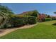 Lush backyard featuring mature landscaping, gravel paths, and vibrant greenery, offering a private outdoor space at 5325 Nicklaus Dr, Winter Haven, FL 33884