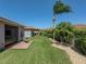 Manicured backyard with green grass, trees, and a patio perfect for relaxing at 5325 Nicklaus Dr, Winter Haven, FL 33884
