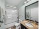 This bathroom features a granite vanity top, a shower with sliding glass door, and great lighting at 5325 Nicklaus Dr, Winter Haven, FL 33884