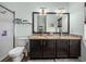 Bathroom features double vanity with granite countertop, framed mirror, and walk-in tiled shower at 5325 Nicklaus Dr, Winter Haven, FL 33884