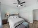 This bedroom features a ceiling fan, and closet with mirrored doors, offering both comfort and ample storage at 5325 Nicklaus Dr, Winter Haven, FL 33884