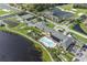 Aerial view of community amenities including a pool, tennis courts, and clubhouse surrounded by lush landscaping and water features at 5325 Nicklaus Dr, Winter Haven, FL 33884