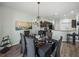 Chandelier-lit dining room with seating for six people and view of the open-plan kitchen at 5325 Nicklaus Dr, Winter Haven, FL 33884