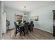 Elegant dining room with modern light fixture and seating for six at 5325 Nicklaus Dr, Winter Haven, FL 33884