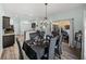 Elegant dining room features a chandelier, seating for six, and sliding glass doors to the patio at 5325 Nicklaus Dr, Winter Haven, FL 33884