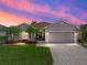 Charming single-story home with a brick driveway, tropical landscaping and a two car garage at 5325 Nicklaus Dr, Winter Haven, FL 33884