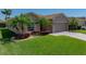 Well maintained single-story home featuring a brick driveway, tropical landscaping and a two-car garage at 5325 Nicklaus Dr, Winter Haven, FL 33884