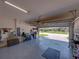 Garage with neutral painted walls, epoxy flooring, and houses outdoor equipment at 5325 Nicklaus Dr, Winter Haven, FL 33884