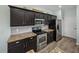 Kitchen features stainless steel appliances, granite counters, tile backsplash and dark cabinetry at 5325 Nicklaus Dr, Winter Haven, FL 33884