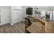Kitchen boasts a breakfast bar with sink, wood-look flooring, and views of the living area at 5325 Nicklaus Dr, Winter Haven, FL 33884