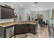 Open-concept kitchen with granite countertops, stainless steel appliances, and views of the dining area at 5325 Nicklaus Dr, Winter Haven, FL 33884