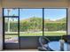 Close up on screened lanai offers a view of the manicured lawn and landscaping at 5325 Nicklaus Dr, Winter Haven, FL 33884