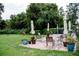 Outdoor patio with seating, potted plants, and lush surroundings for relaxation and enjoyment at 5325 Nicklaus Dr, Winter Haven, FL 33884