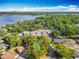 Gorgeous aerial shot of a wooded homesite near a tranquil lake, with a backdrop of beautiful sky at 5402 Parkway Drive, Belle Isle, FL 32809