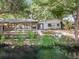Backyard pool area with waterfront views and a covered dock, blending relaxation with scenic beauty at 5402 Parkway Drive, Belle Isle, FL 32809