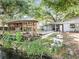 A beautiful backyard featuring a pool, gazebo, canal access and mature trees at 5402 Parkway Drive, Belle Isle, FL 32809