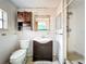 A full view of a bathroom featuring white tiles, dark cabinets and a shower at 5402 Parkway Drive, Belle Isle, FL 32809