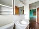A bathroom with a white sink and toilet featuring a door into a bedroom at 5402 Parkway Drive, Belle Isle, FL 32809
