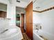 Outdated bathroom featuring a white sink, toilet, and shower with decorative tiles at 5402 Parkway Drive, Belle Isle, FL 32809