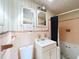 Bathroom featuring a white sink, toilet, and vanity, accented with vintage peach tiling and fixtures at 5402 Parkway Drive, Belle Isle, FL 32809