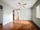 Bedroom featuring hardwood floors, a ceiling fan, and a window for natural light at 5402 Parkway Drive, Belle Isle, FL 32809