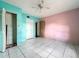 Spacious bedroom featuring tile flooring, ceiling fan, and access to closets at 5402 Parkway Drive, Belle Isle, FL 32809