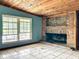 Room with wood ceiling, brick fireplace, and large windows at 5402 Parkway Drive, Belle Isle, FL 32809